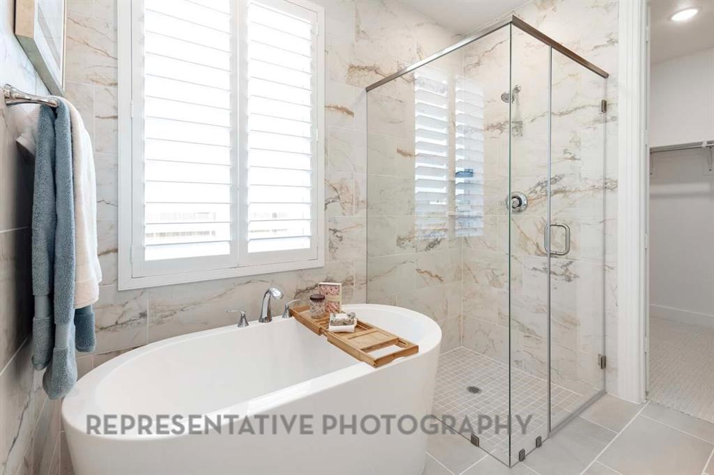 2140 Nerello Way Rockwall, TX 75032 - Photo 17 of 36 a bath tub sitting next to a white sink and a shower