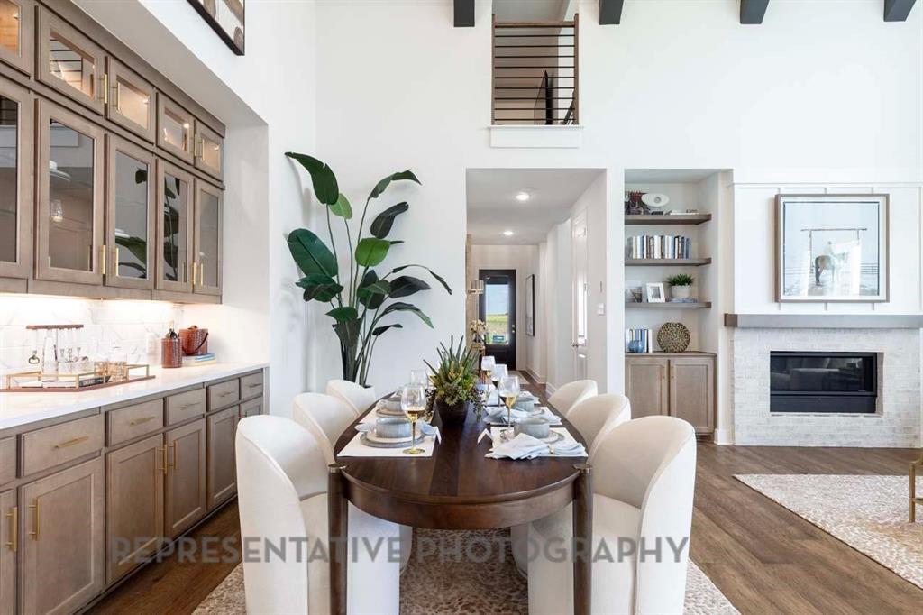 2140 Nerello Way Rockwall, TX 75032 - Photo 24 of 36 a living room with furniture a potted plant and a fireplace