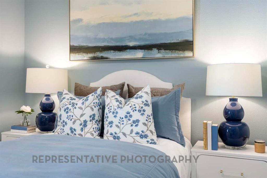 2140 Nerello Way Rockwall, TX 75032 - Photo 29 of 36 a bedroom with a bed and lamp