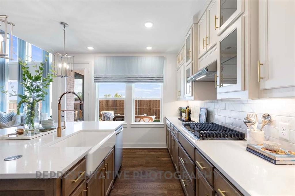 2140 Nerello Way Rockwall, TX 75032 - Photo 6 of 36 a kitchen with a sink stove and cabinets