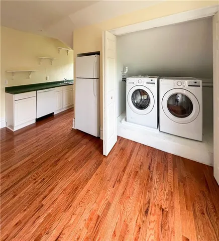 a view of kitchen and utility room with wooden floor