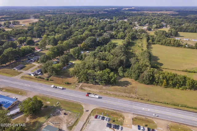 an aerial view of a houses with a yard