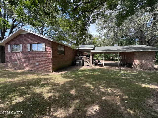 a front view of a house with a yard and a garage