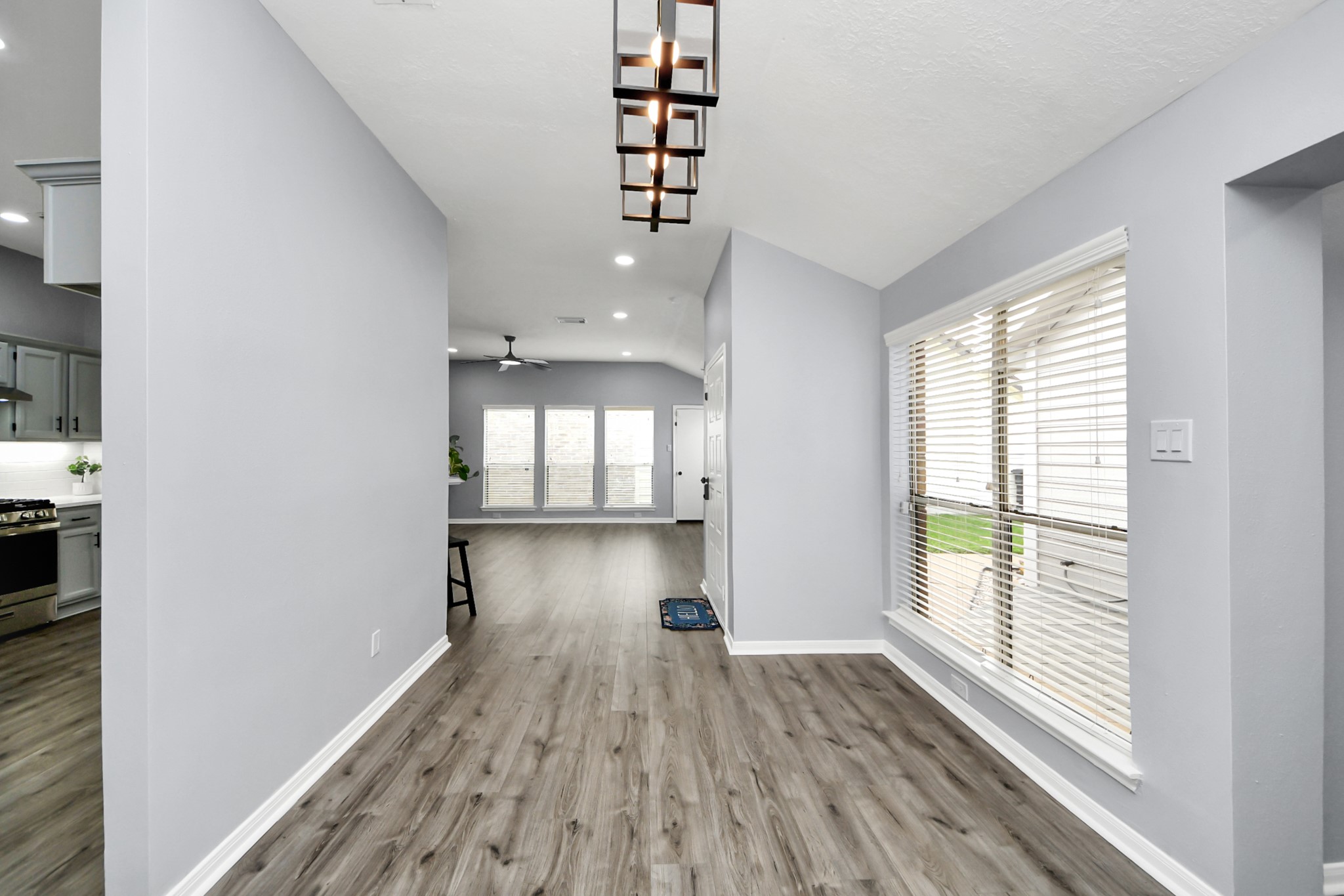 11830 Plumpoint Drive Houston, TX 77099 - Photo 15 of 40 a view of empty room with wooden floor and fan