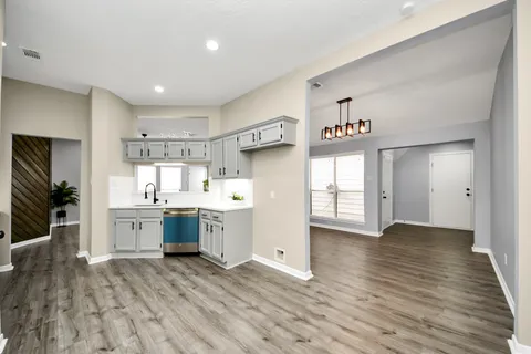 a kitchen with stainless steel appliances granite countertop a lot of counter top space and cabinets