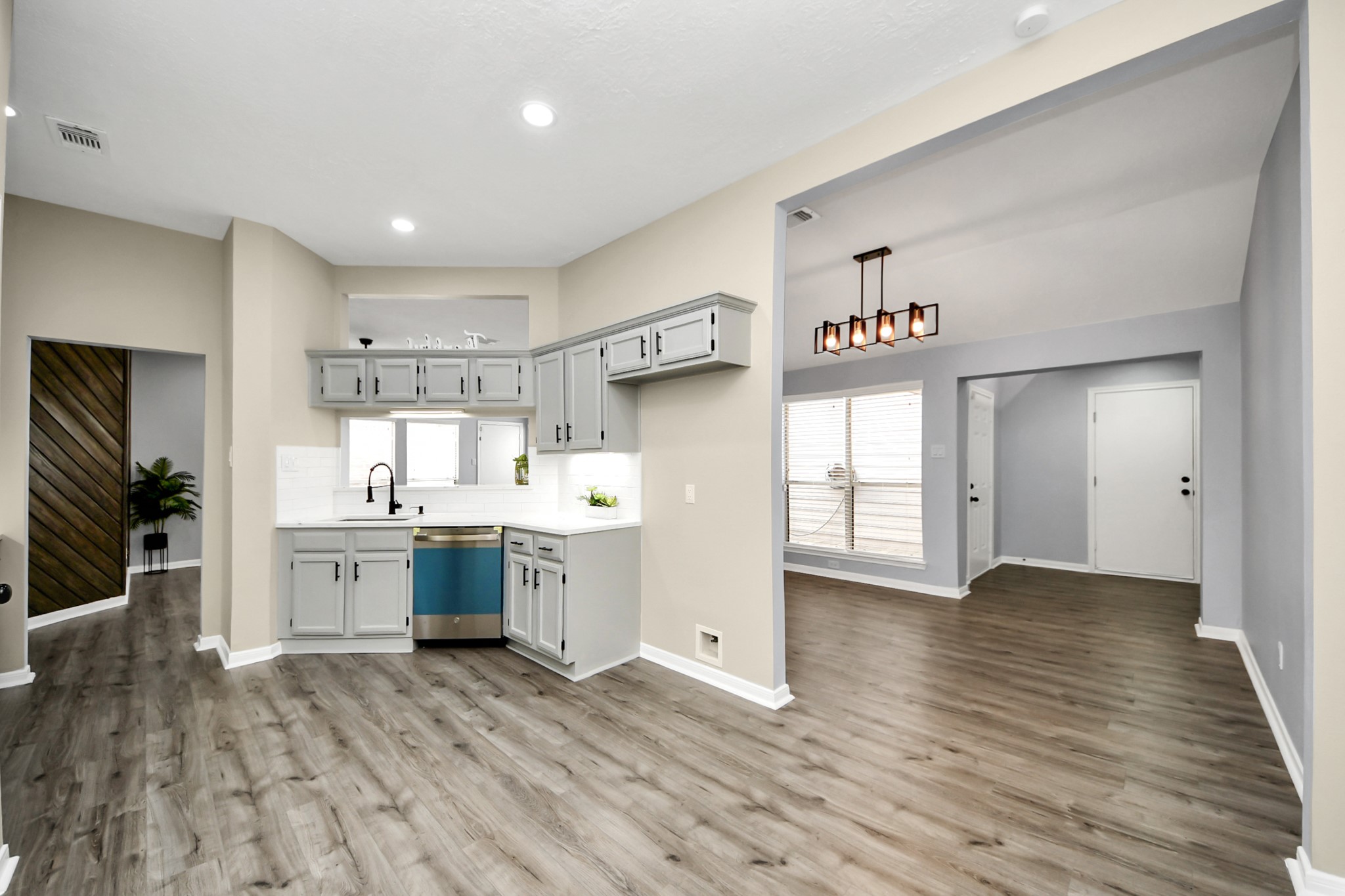 11830 Plumpoint Drive Houston, TX 77099 - Photo 22 of 40 a kitchen with granite countertop a stove cabinets and wooden floor