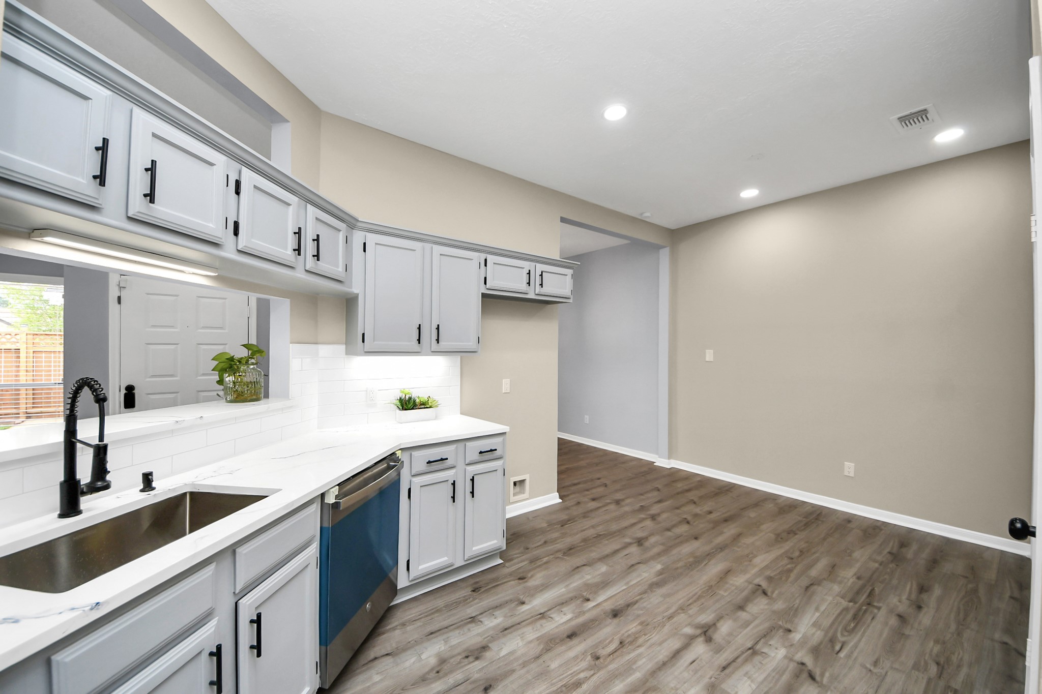 11830 Plumpoint Drive Houston, TX 77099 - Photo 25 of 40 a kitchen with a sink cabinets and wooden floor