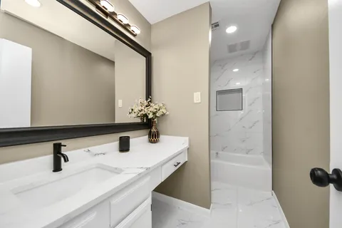 a bathroom with a sink and a mirror