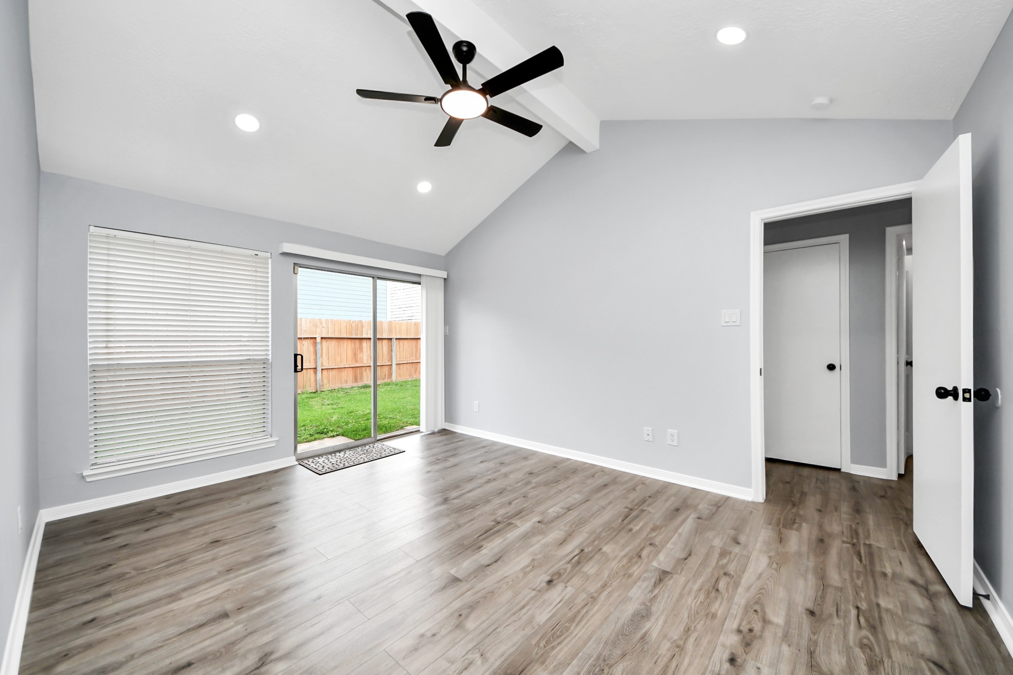 11830 Plumpoint Drive Houston, TX 77099 - Photo 32 of 40 a view of an empty room with wooden floor and a window