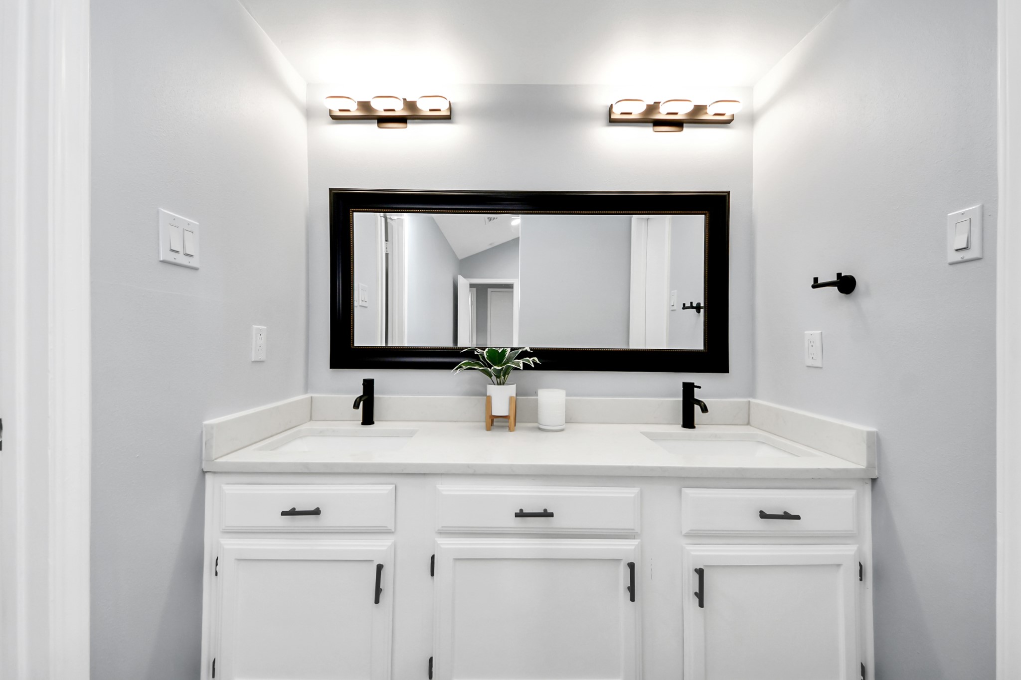 11830 Plumpoint Drive Houston, TX 77099 - Photo 33 of 40 a bathroom with double vanity sinks and a mirror