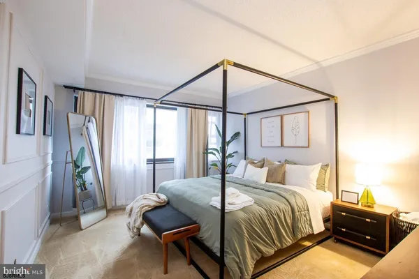 a bedroom with a bed and a mirror