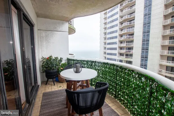 a view of a chair and table in the balcony