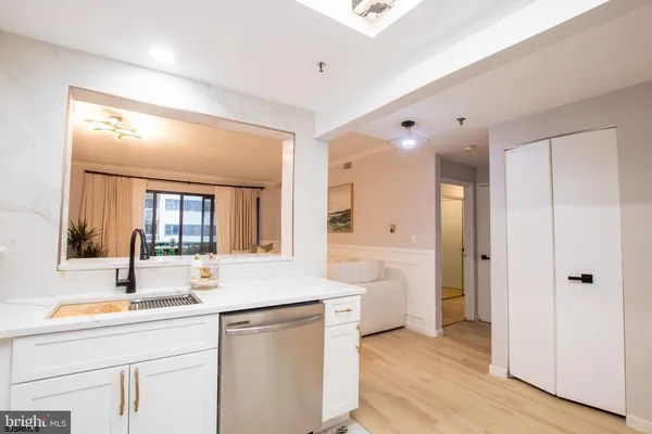 a bathroom with a double vanity sink and mirror with shower