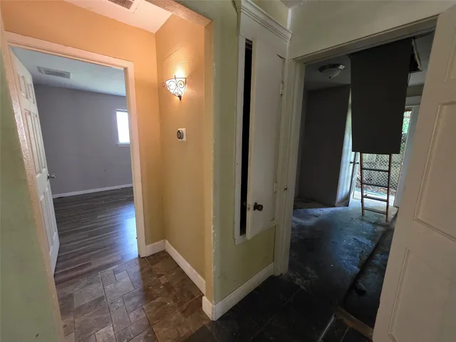 wooden floor in an empty room with a window