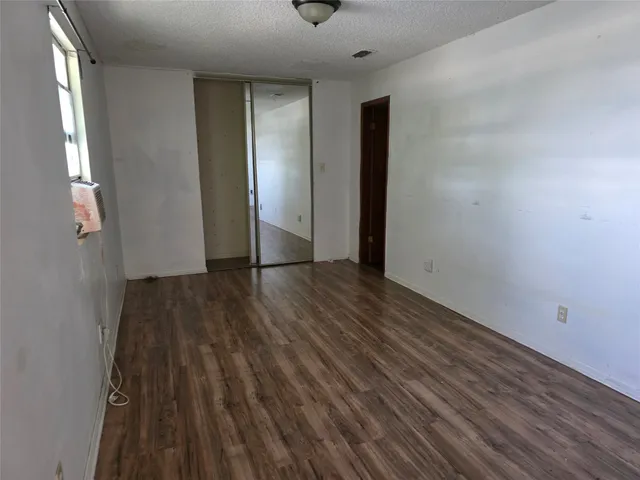 a yellow house with trees in front of it