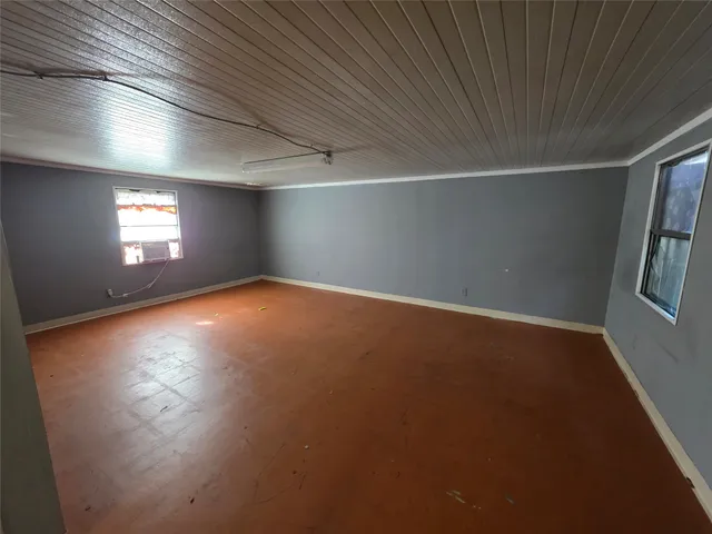 a view of a hallway with wooden floor and closet area