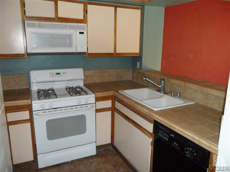 1031 Waltham Road, Unit E Simi Valley, CA 93065 - Photo 4 of 10 a kitchen with a stove and a sink