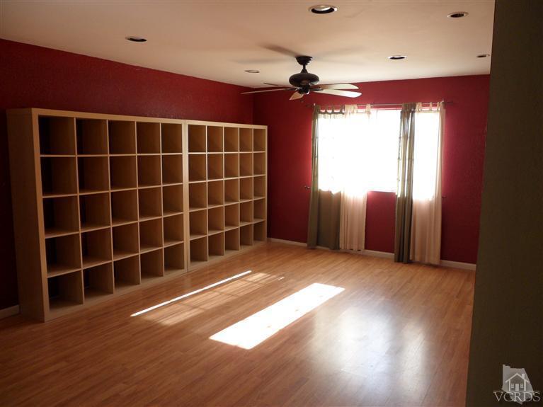 1031 Waltham Road, Unit E Simi Valley, CA 93065 - Photo 6 of 10 a view of an empty room with a window and wooden floor