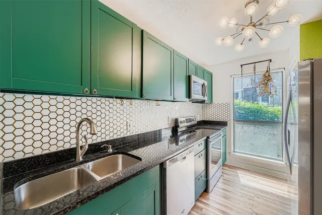 a kitchen with a sink and a stove top oven