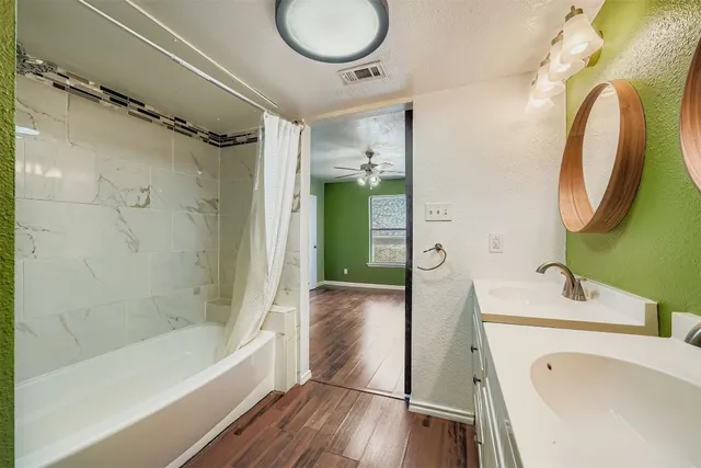 a bathroom with a tub sink and mirror