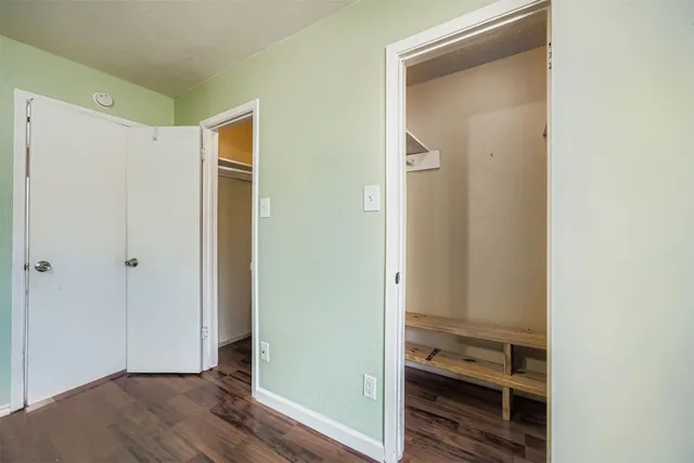 a view of hallway with wooden floor