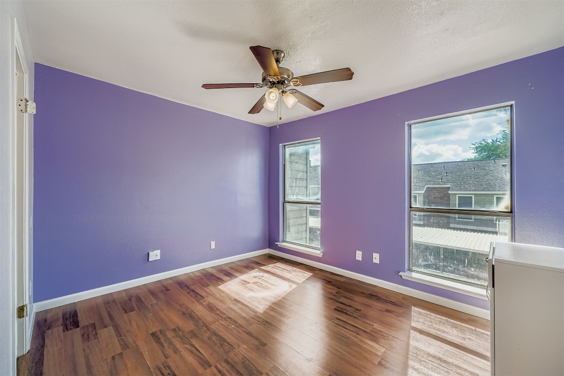 2018 West Rundberg Lane, Unit 2B Austin, TX 78758 - Photo 23 of 31 Spare room featuring wood finished floors, a ceiling fan, and a textured ceiling