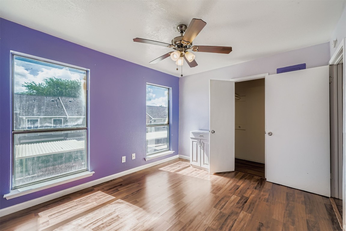 2018 West Rundberg Lane, Unit 2B Austin, TX 78758 - Photo 25 of 31 Unfurnished bedroom featuring dark wood-style floors and ceiling fan