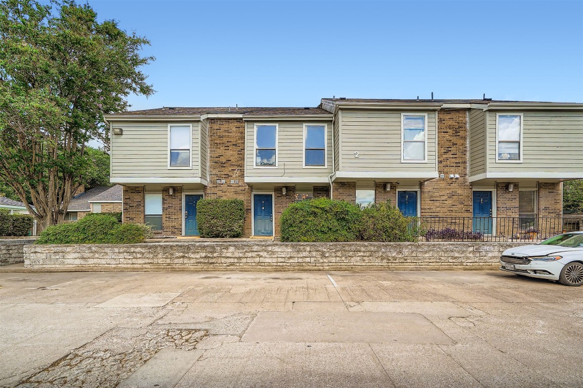 2018 West Rundberg Lane, Unit 2B Austin, TX 78758 - Photo 31 of 31 View of front facade featuring brick siding and uncovered parking