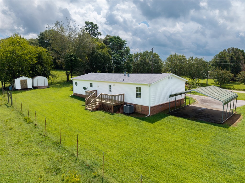 503 Mulliken Road Central, SC 29630 - Photo 32 of 50 A verdant lawn surrounds this home with an inviting rear deck and practical carport.