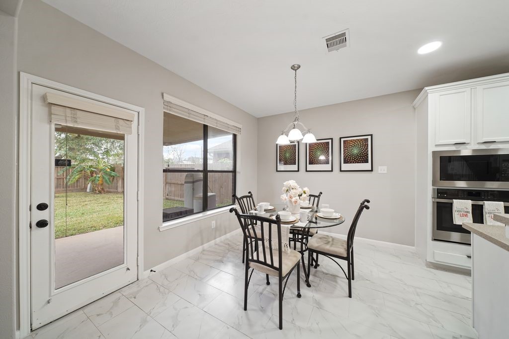 714 Coggins Point Way Sugar Land, TX 77479 - Photo 11 of 32 a view of a dining room with furniture window and wooden floor