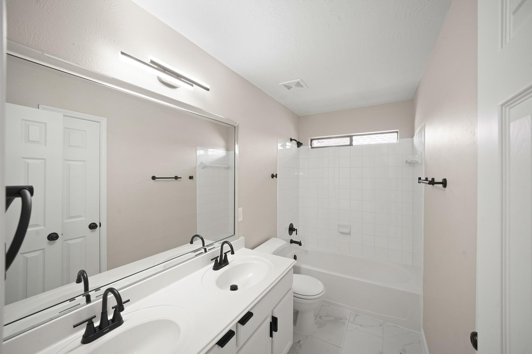 714 Coggins Point Way Sugar Land, TX 77479 - Photo 22 of 32 a bathroom with a sink a toilet and shower