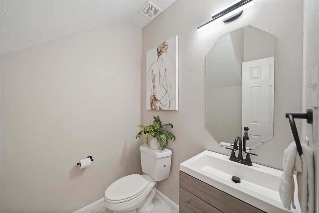 714 Coggins Point Way Sugar Land, TX 77479 - Photo 28 of 32 a bathroom with a sink mirror and toilet