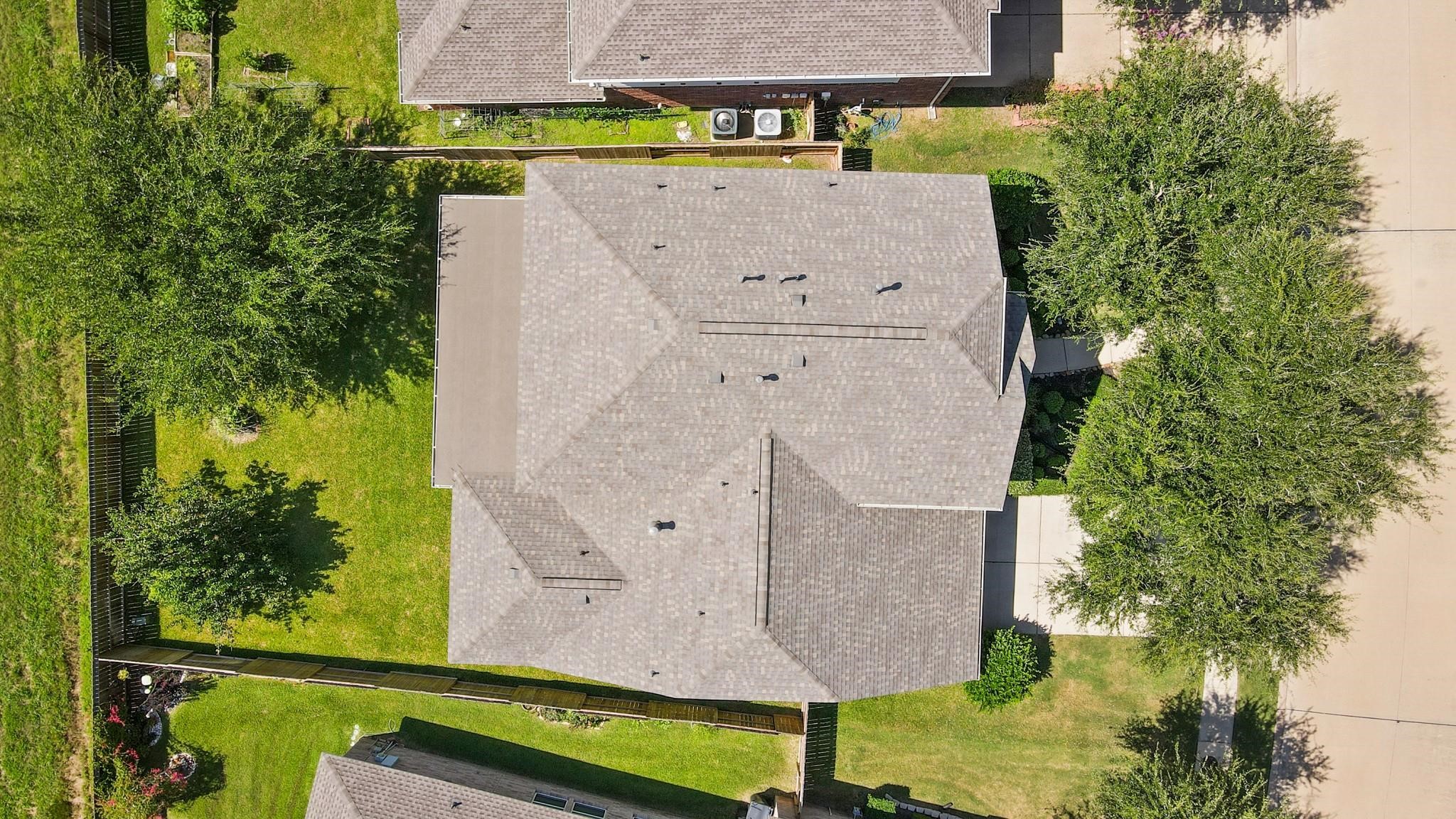 714 Coggins Point Way Sugar Land, TX 77479 - Photo 3 of 32 an aerial view of a house with a garden and large trees