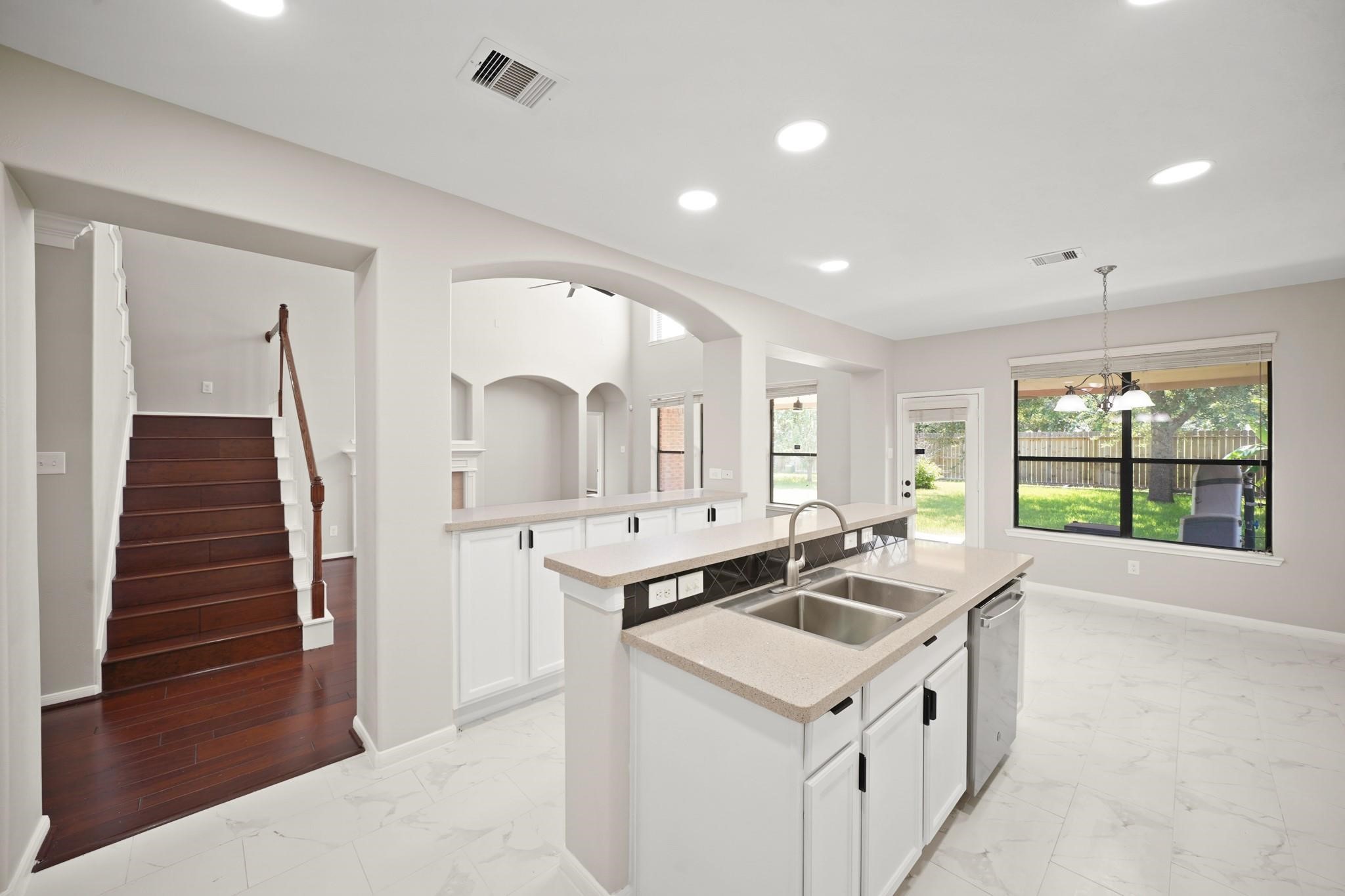 714 Coggins Point Way Sugar Land, TX 77479 - Photo 10 of 32 a kitchen that has a sink a stove and a refrigerator