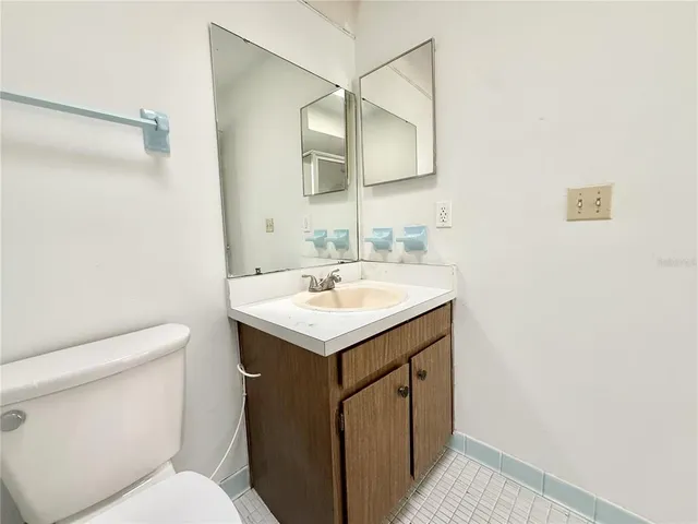 a bathroom with a sink toilet vanity and a mirror