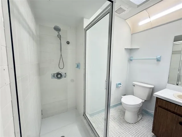 a bathroom with a toilet and a shower