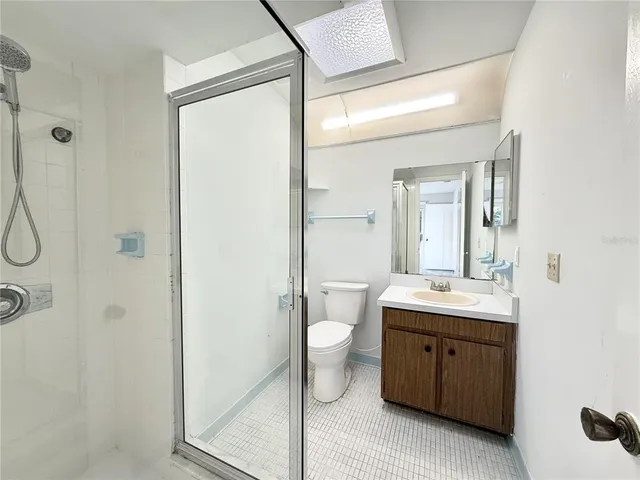 a bathroom with a double vanity sink toilet and shower