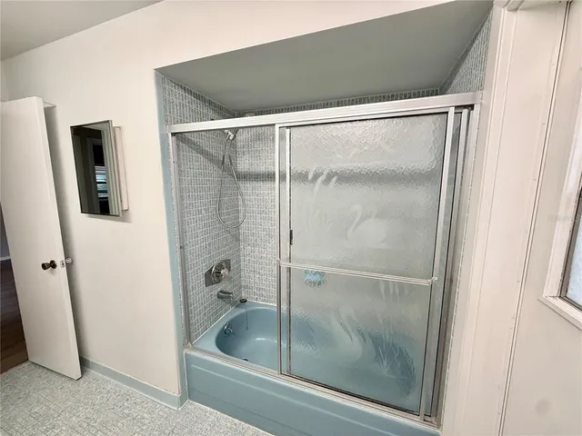 a bathroom with a glass shower door