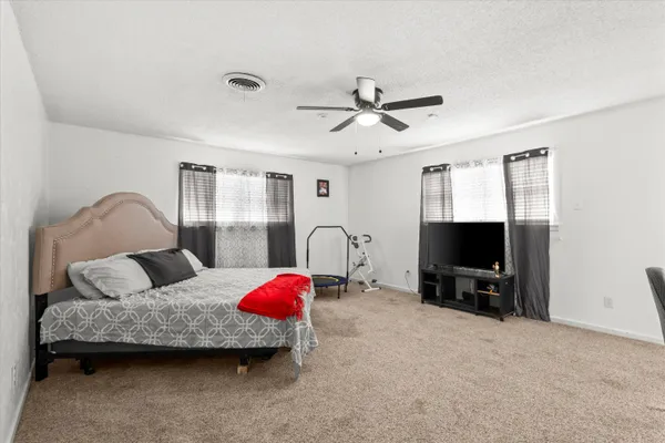 a bedroom with furniture and a flat screen tv