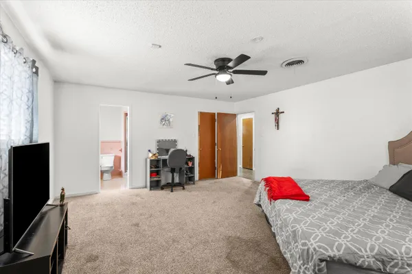 a bedroom with furniture and a flat screen tv