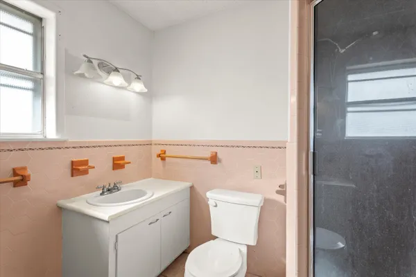 a bathroom with a sink a toilet and mirror