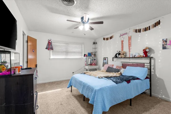 a bedroom with a bed and a chandelier