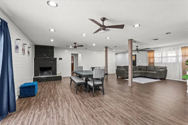 a living room with furniture and a wooden floor