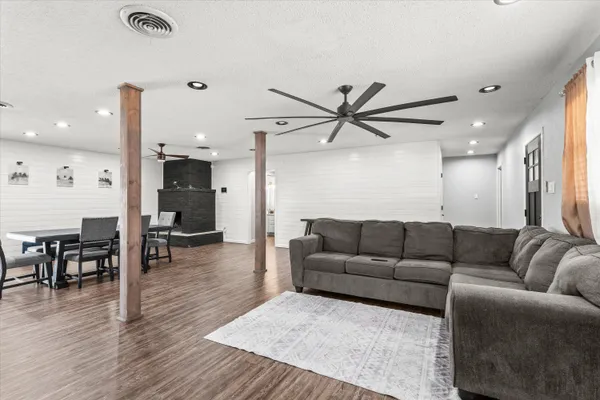 a living room with furniture and a wooden floor