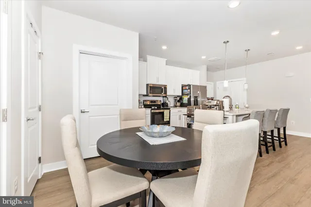 a large kitchen with a table and chairs