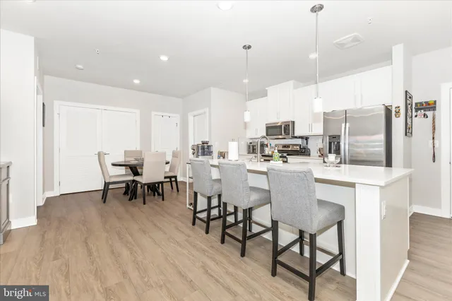 a kitchen with kitchen island a sink appliances and cabinets