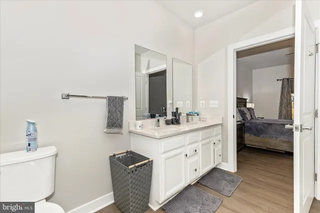 a bathroom with a double vanity sink toilet and shower