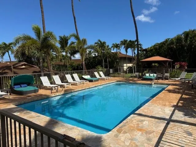 a view of a swimming pool with lounge chairs