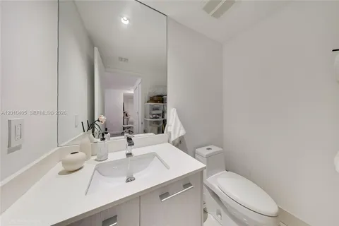 a bathroom with a toilet a sink and mirror