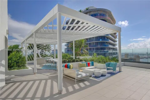 a view of a patio with couches and potted plants